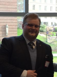 Man in suit standing in front of window