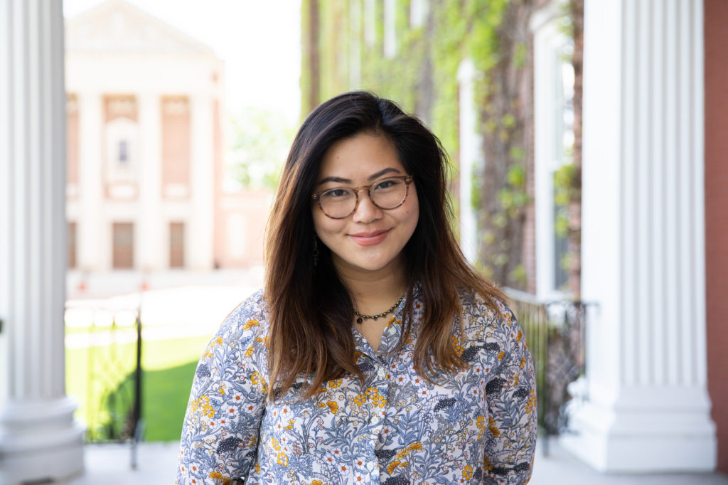 Student (Mia Yee) smiling at camera on Fenwick Porch